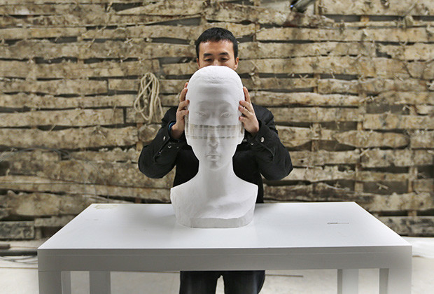 Chinese artist Li Hongbo shows his paper sculpture work, made of 6,000 pieces of paper, on the outskirts of Beijing