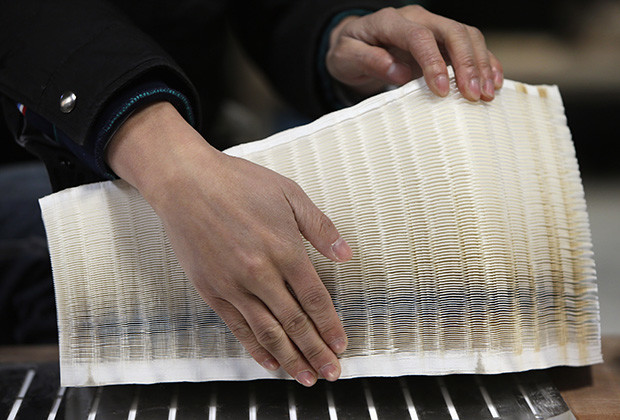 Chinese artist Li shows 500 pieces of paper, which are pasted with hollows, as the material for his paper sculptures on the outskirts of Beijing